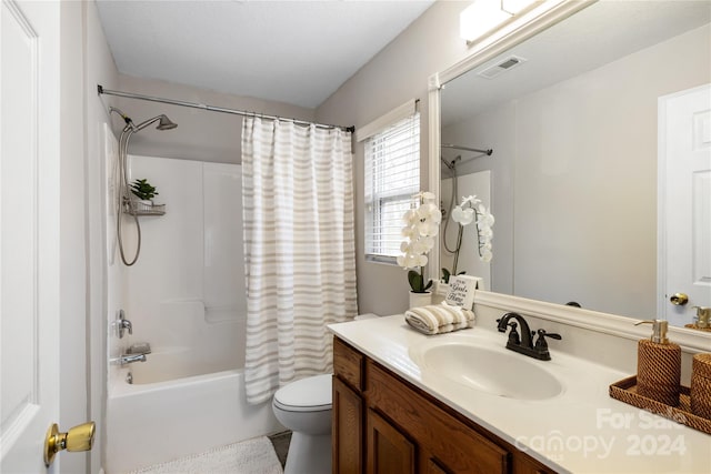 full bathroom featuring shower / bath combination with curtain, toilet, and vanity