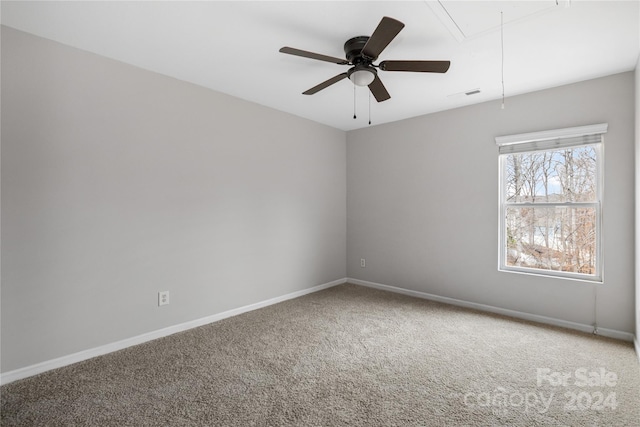 carpeted spare room featuring ceiling fan