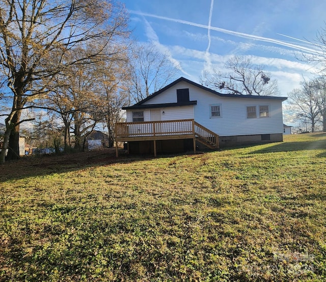 back of house with a yard and a deck