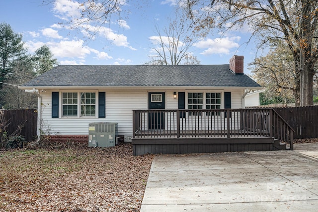 rear view of house featuring cooling unit and a deck