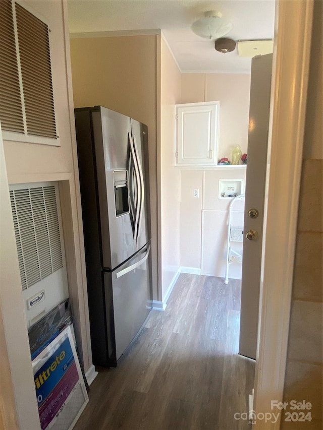 kitchen featuring hardwood / wood-style flooring and stainless steel fridge