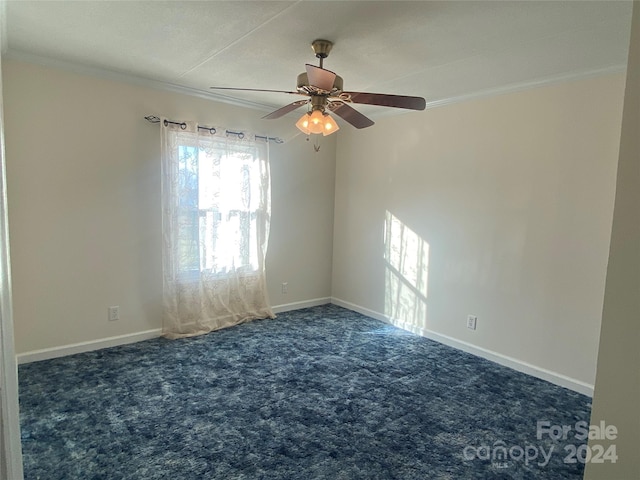 carpeted spare room featuring ceiling fan and ornamental molding