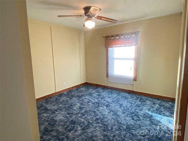 spare room featuring carpet flooring and ceiling fan