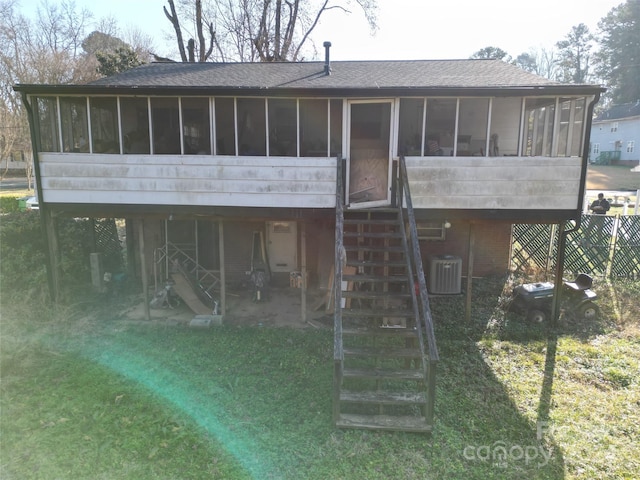 back of property featuring a yard, central air condition unit, and a sunroom