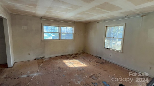 unfurnished room featuring plenty of natural light