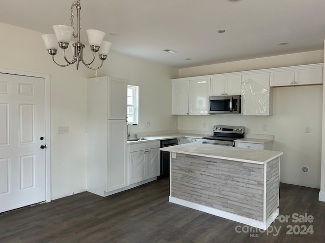 kitchen featuring dark hardwood / wood-style flooring, white cabinets, a kitchen island, and appliances with stainless steel finishes