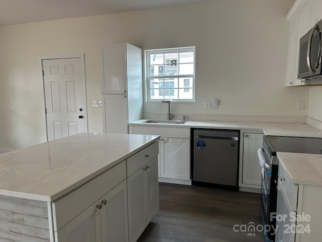 kitchen featuring white cabinetry, sink, appliances with stainless steel finishes, and dark wood-type flooring