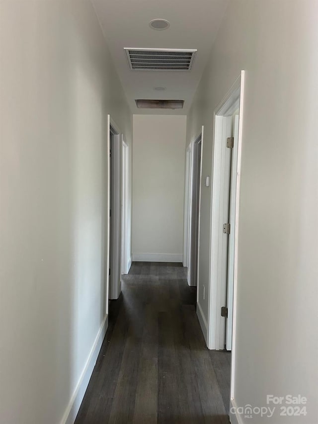 corridor featuring dark wood-type flooring