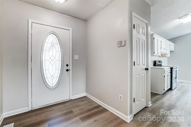 foyer with hardwood / wood-style flooring and a textured ceiling