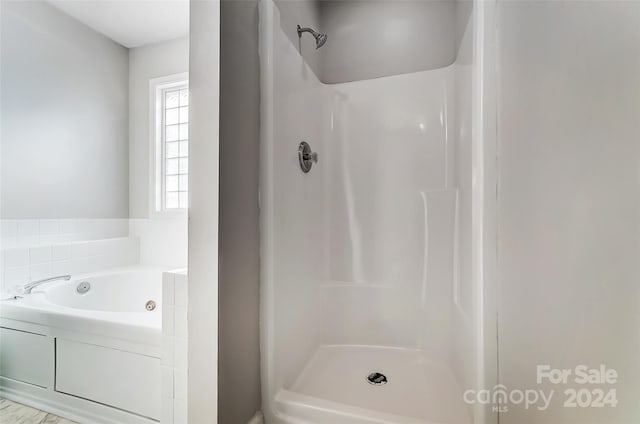 bathroom featuring independent shower and bath