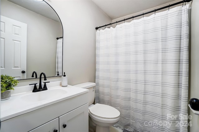 bathroom featuring vanity, toilet, and a textured ceiling