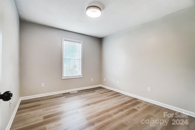 unfurnished room with light hardwood / wood-style floors