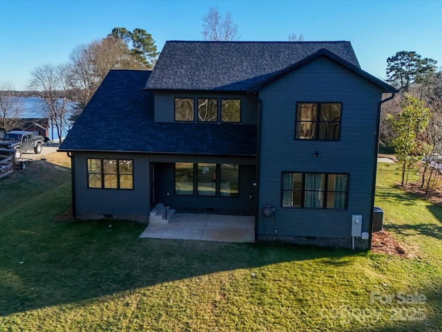 rear view of property with a patio and a lawn