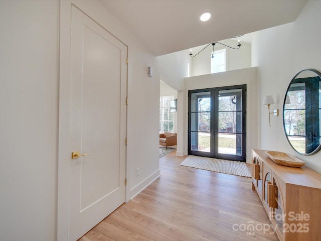 entryway featuring french doors and light hardwood / wood-style flooring