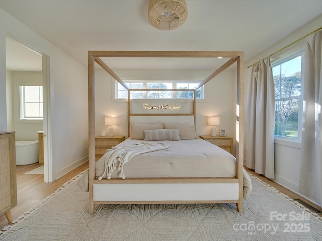 bedroom featuring baseboards and light wood-style floors