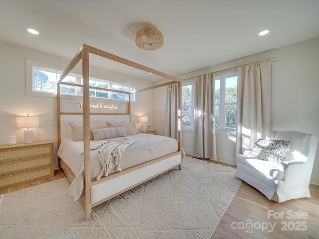 bedroom with recessed lighting and wood finished floors