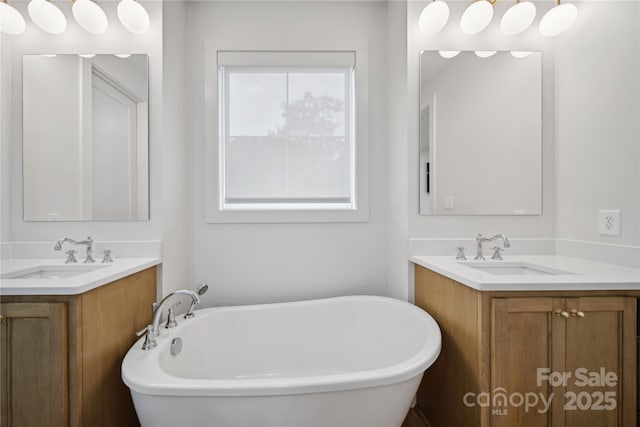 bathroom with vanity and a tub