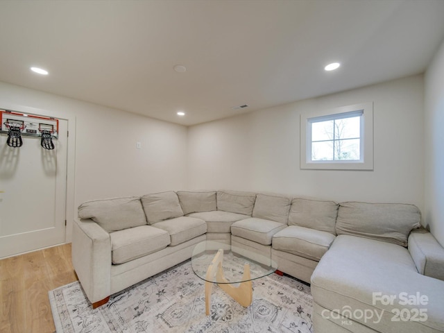 living room with recessed lighting, light wood-type flooring, and visible vents