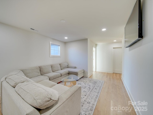 living room featuring light wood-style flooring, recessed lighting, baseboards, and visible vents