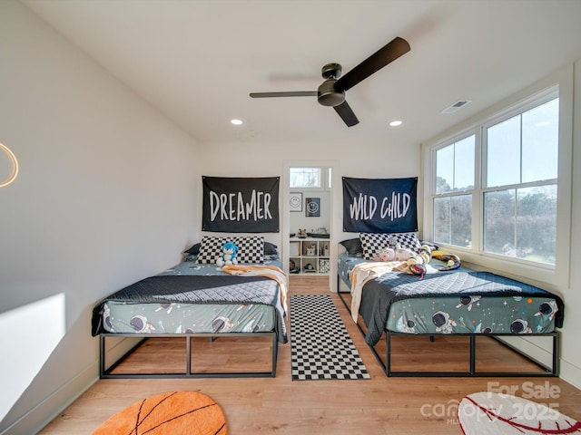 bedroom with recessed lighting, visible vents, wood finished floors, and a ceiling fan