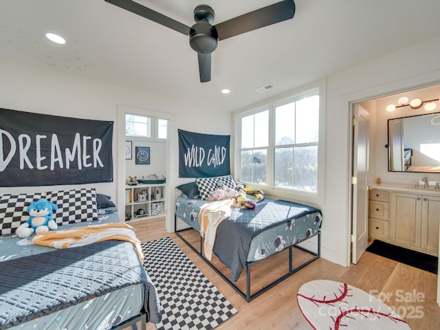 bedroom with visible vents, recessed lighting, light wood-style flooring, a ceiling fan, and a sink