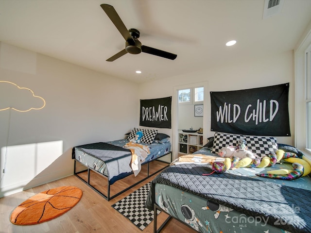 bedroom featuring recessed lighting, visible vents, wood finished floors, and a ceiling fan