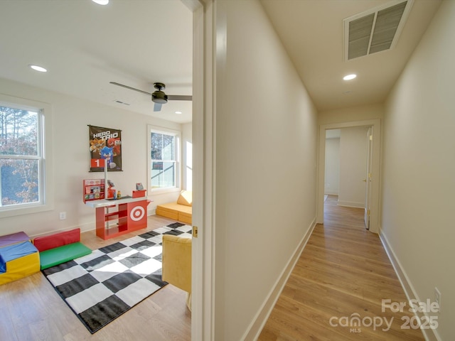 corridor with recessed lighting, visible vents, light wood finished floors, and baseboards