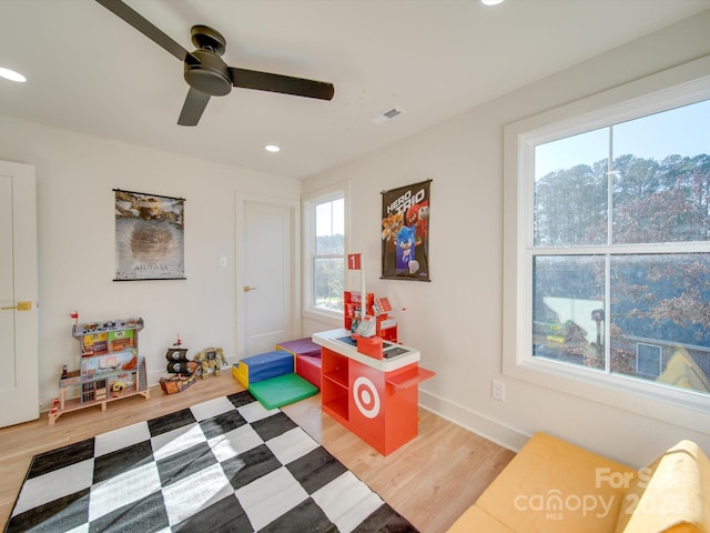 playroom with hardwood / wood-style floors and ceiling fan