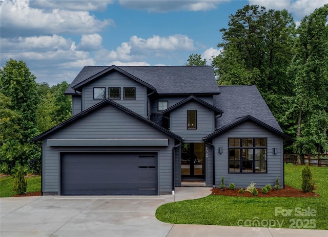 view of front of home with driveway, a front lawn, and roof with shingles