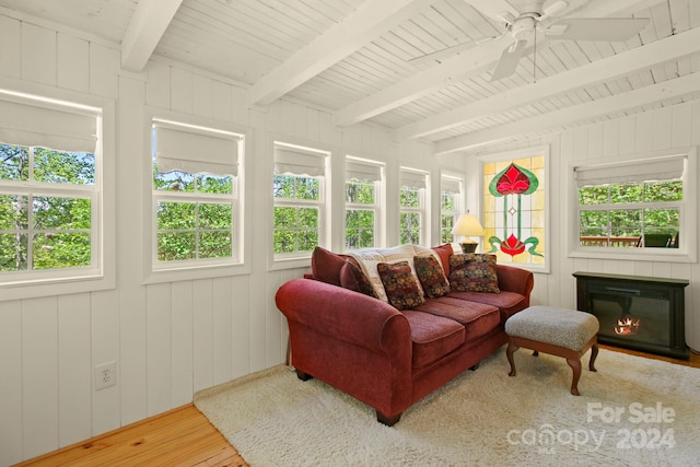 sunroom with beamed ceiling, ceiling fan, and a healthy amount of sunlight