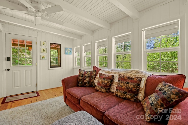 sunroom / solarium with ceiling fan, beamed ceiling, and wooden ceiling