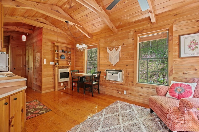 interior space featuring hardwood / wood-style floors, heating unit, and a wealth of natural light