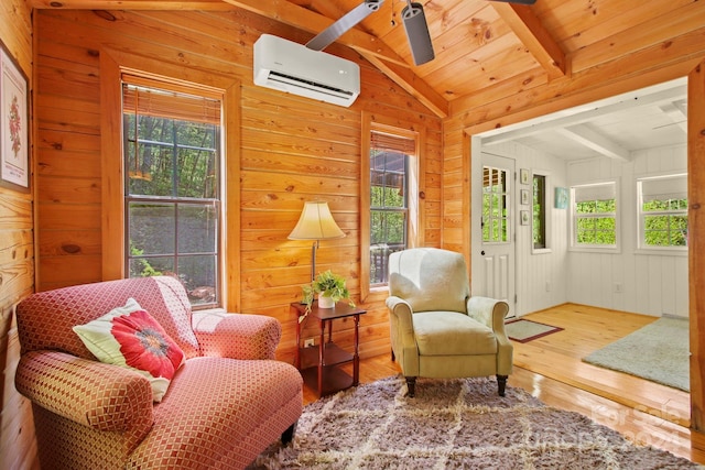 living area featuring wood walls, lofted ceiling with beams, wood-type flooring, wood ceiling, and a wall unit AC