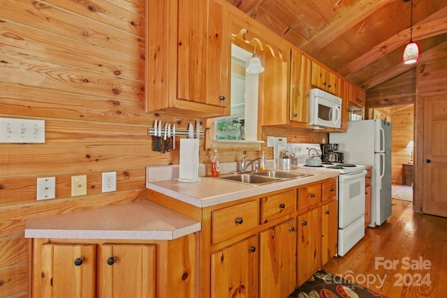 kitchen featuring wood walls, decorative light fixtures, lofted ceiling with beams, and white appliances