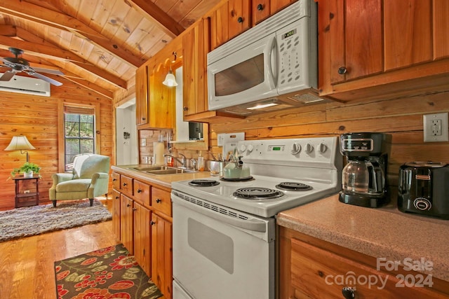 kitchen featuring vaulted ceiling with beams, a wall mounted AC, wood-type flooring, white appliances, and wooden walls