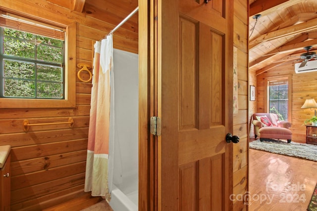 bathroom with wooden ceiling, walk in shower, lofted ceiling with beams, a wall mounted AC, and wood walls