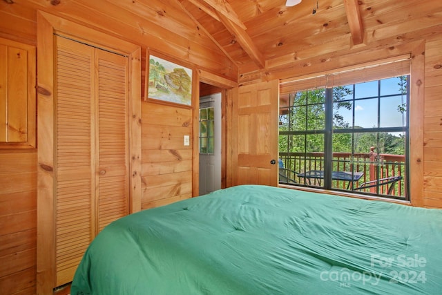 bedroom featuring vaulted ceiling with beams, a closet, wooden ceiling, and wood walls