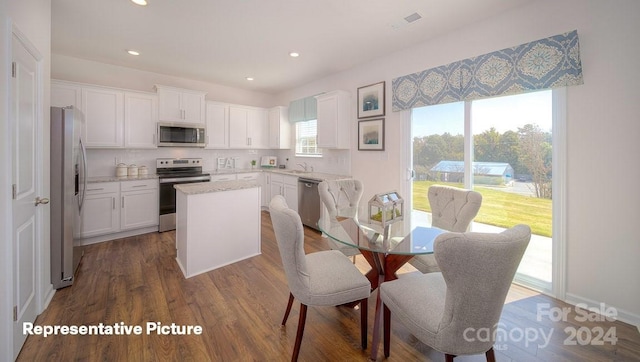 dining area with dark hardwood / wood-style flooring and sink