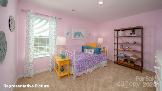 bedroom featuring light carpet