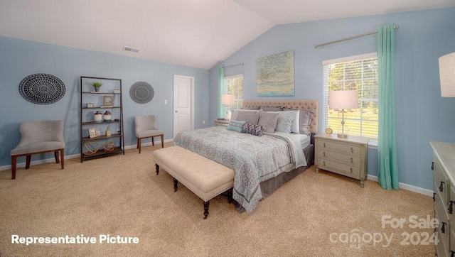 bedroom featuring light carpet and vaulted ceiling