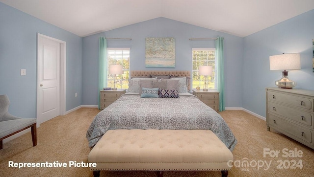 bedroom featuring vaulted ceiling, light carpet, and multiple windows