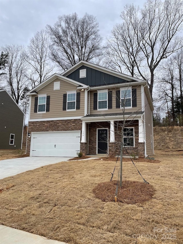 craftsman-style home with driveway, an attached garage, and board and batten siding