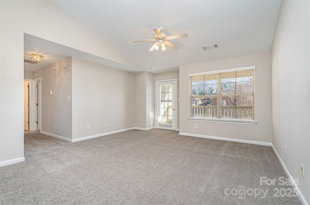 carpeted spare room with ceiling fan and lofted ceiling