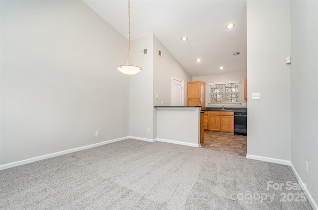 kitchen with dishwasher, decorative light fixtures, light colored carpet, and vaulted ceiling