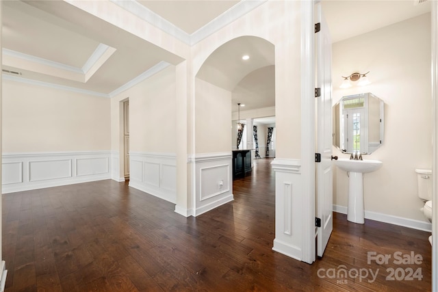 corridor with dark hardwood / wood-style flooring and ornamental molding