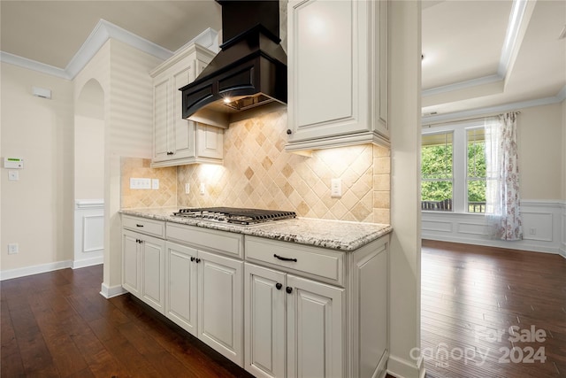 kitchen featuring stainless steel gas stovetop, dark hardwood / wood-style floors, white cabinetry, and custom range hood