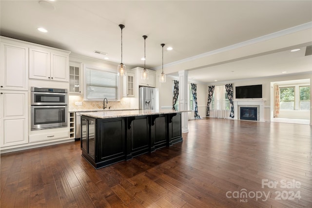 kitchen with white cabinetry, a center island, stainless steel appliances, a kitchen breakfast bar, and dark hardwood / wood-style floors