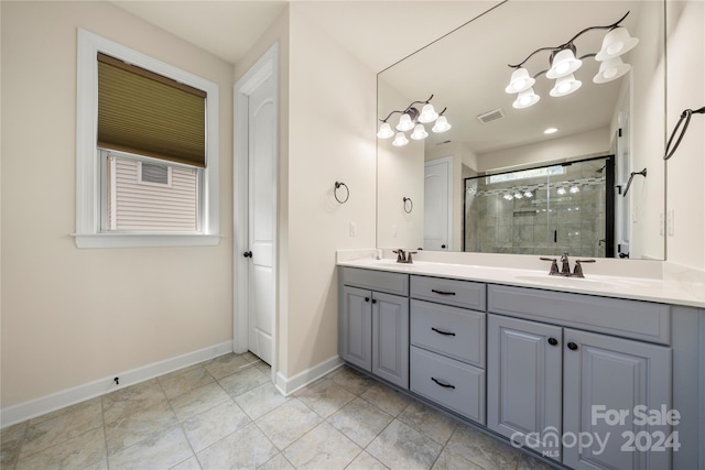 bathroom with tile patterned flooring, vanity, and an enclosed shower