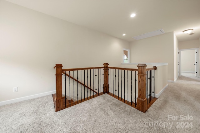 corridor featuring light colored carpet