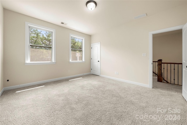 empty room featuring light carpet